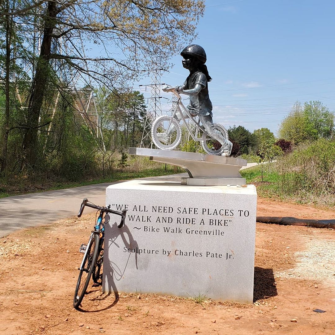 statue: a little girl rides a bicycle