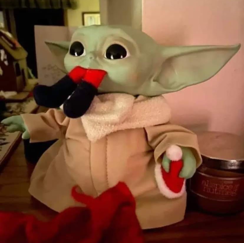 Grogu (baby Yoda) is eating an Elf.
